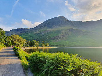 Scenic view of lake and mountains against sky