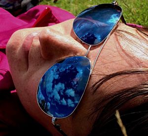 Close-up of woman holding sunglasses