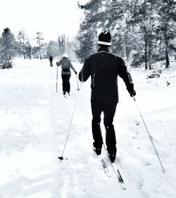 People walking on snow covered landscape