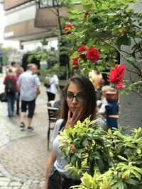 Rear view of woman with pink flowers on street