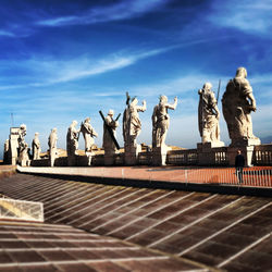 Low angle view of statues against sky