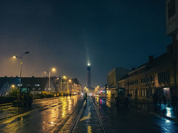 Illuminated city street and buildings at night