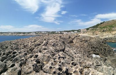 Rocks on beach against sky