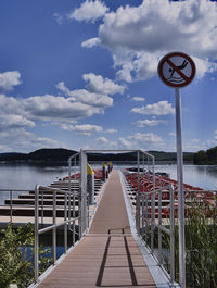 Pier over lake against sky