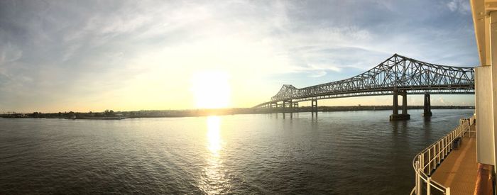 View of bridge over river at sunset