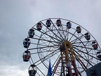 Low angle view of ferris wheel against sky