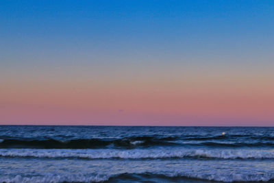 Scenic view of sea against clear sky during sunset