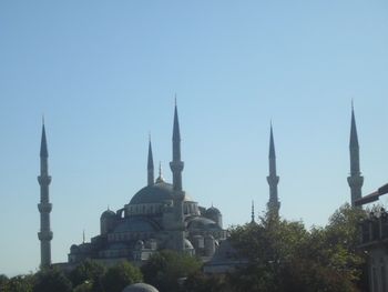 View of mosque against clear blue sky