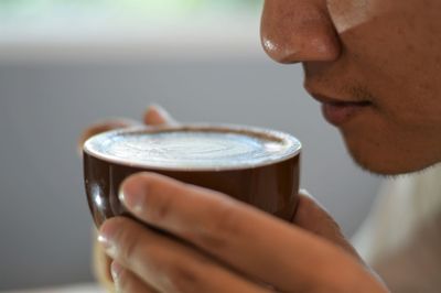 Close-up of man holding drink