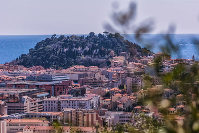 Aerial view of cityscape by sea against sky