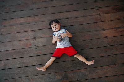 High angle view of girl standing on wood