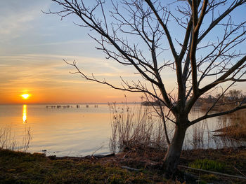 Scenic view of lake against sky during sunset