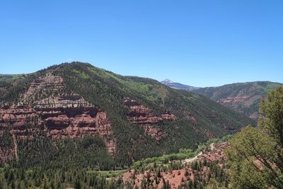 Scenic view of mountains against clear blue sky