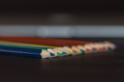 Close-up of multi colored pencils on table