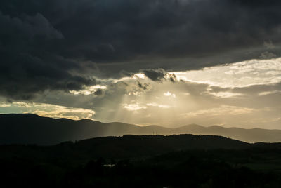 Silhouette mountains against dramatic sky