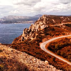 Scenic view of mountain road against sky