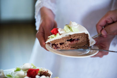 Close-up of couple holding cake