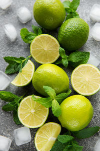 Lime and mint on a dark background. the ingredients for making refreshing drinks and cocktails.