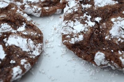 High angle view of cookies with powdered sugar on table
