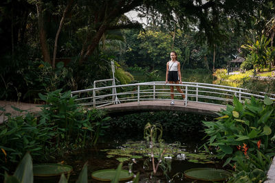 Girl standing on the bridge in the park 