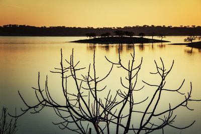 Scenic view of lake at sunset