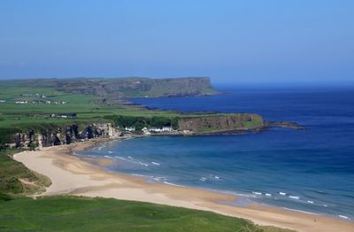 Scenic view of sea against clear blue sky