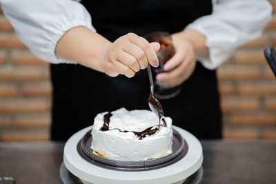 Midsection of man holding ice cream