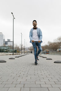 Man commuting in the city, using his kickboard