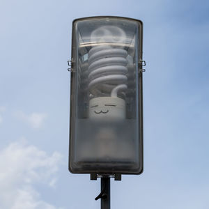 Low angle view of telephone pole against sky