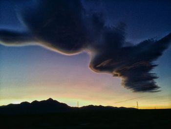 Silhouette of landscape against dramatic sky