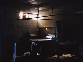 Man sitting on table in illuminated room
