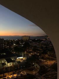 High angle view of illuminated buildings against sky during sunset