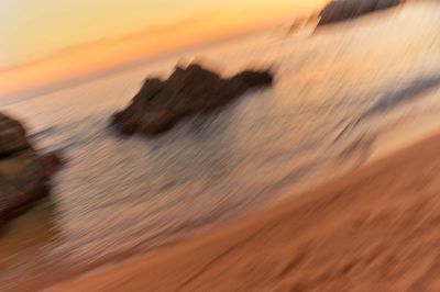 Close-up of sea against sky during sunset