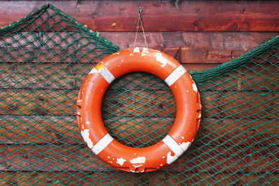 Close-up of inflatable ring hanging against fishing net