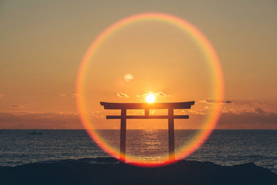 Close-up of illuminated lighting equipment against sky during sunset