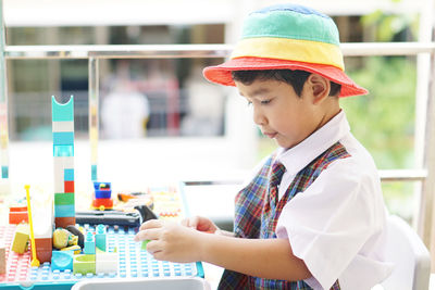 Side view of boy looking at camera