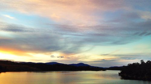 Scenic view of lake against sky during sunset