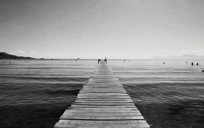 Pier on sea against clear sky