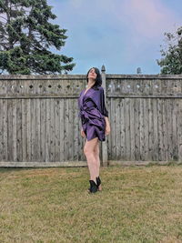 Full length of woman standing against plants