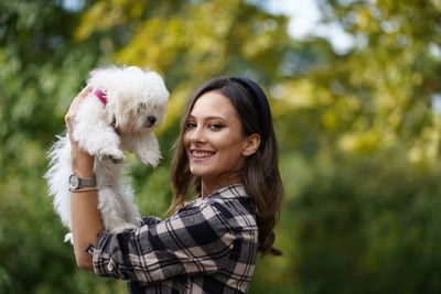 Portrait of a smiling young woman with dog