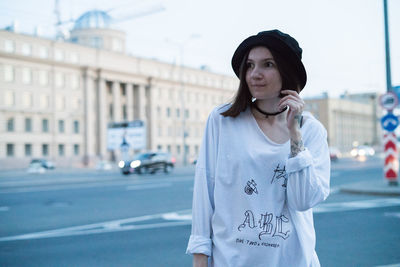 Young woman looking at city street