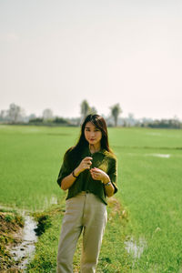 Young woman standing on field