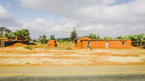 Built structure on landscape against sky