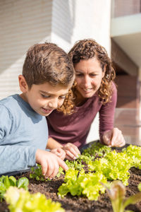 Mother and son working on a urban garden at home