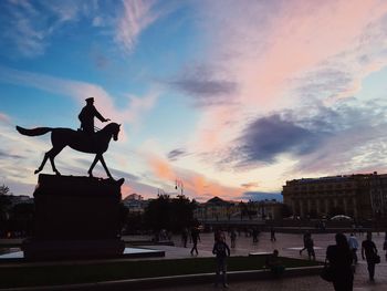 Silhouette of statue against cloudy sky