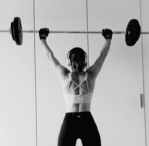 Back woman weight lifting