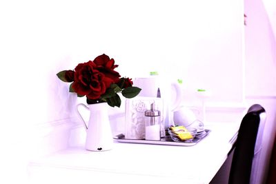 Close-up of roses in vase on table