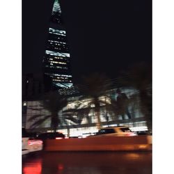 Illuminated city street and buildings at night