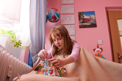 Girl playing with toy at home