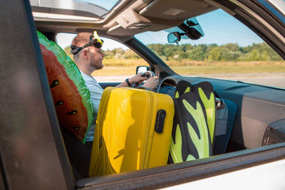 Low section of man driving car